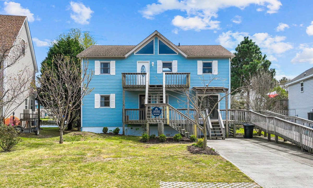 Colington Harbour House | Dog-friendly home with canal views, dock, kayaks, sunroom, deck, & firepit