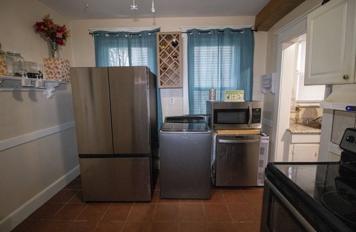 West New Haven Apartment | 2BR w/Game Room & Gym, King Bed + Bunks, Outdoor TV, Yard, Parking, Pets welcome