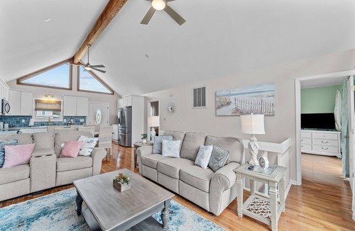 Colington Harbour House | Dog-friendly home with canal views, dock, kayaks, sunroom, deck, & firepit