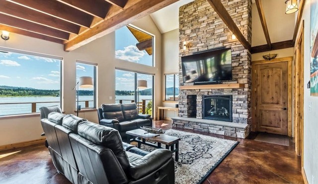 Custom riverfront home with private dock, game room, hot tub & heated floors